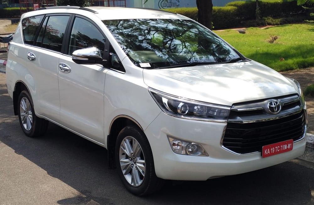 A white Toyota Innova Crysta